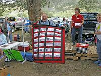  Here, Don Neil displays the Dawson quilt he won to the Dawson Reunion attendees.